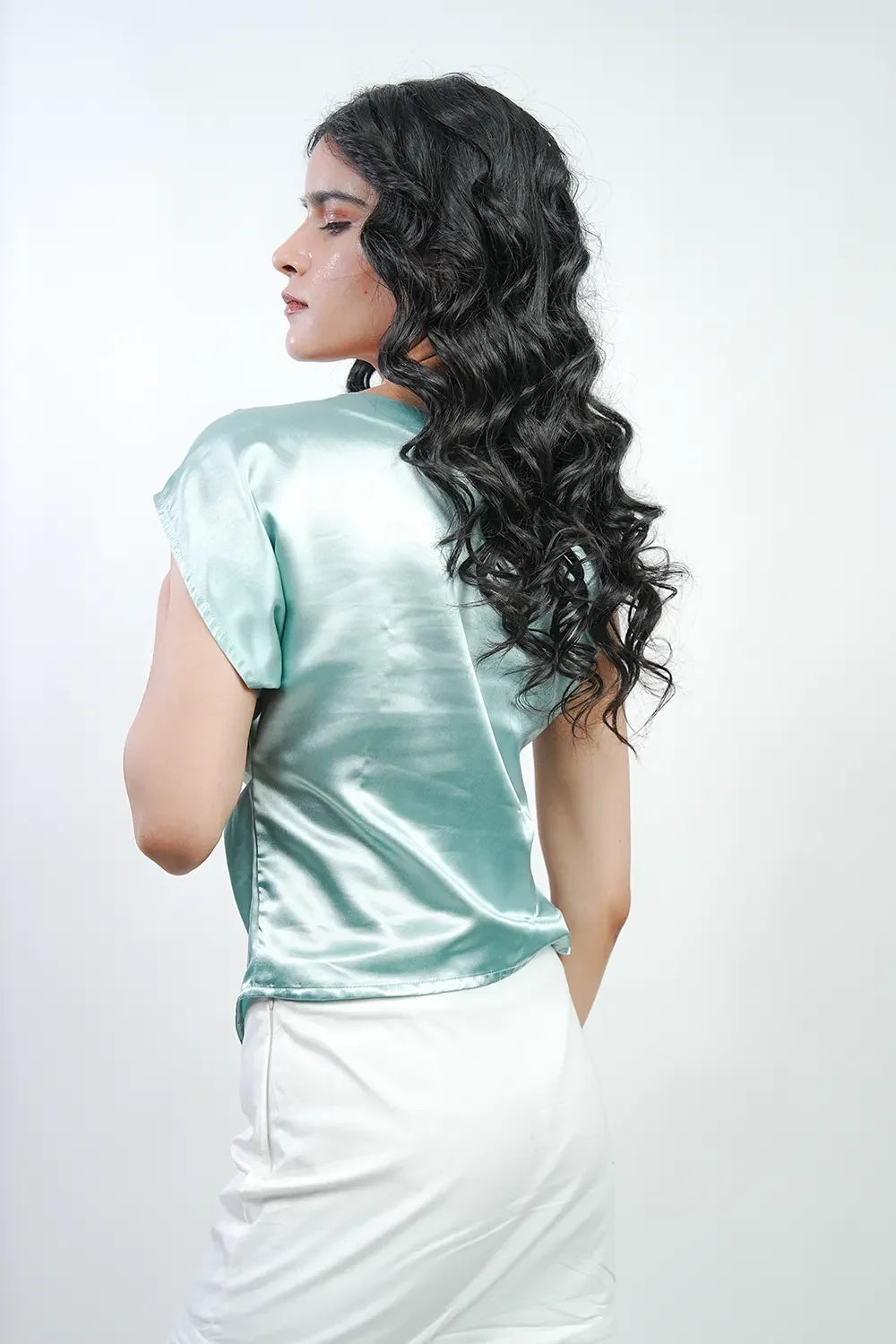 Woman in pastel green satin top and white skirt, Streiq Uniquely You fashion