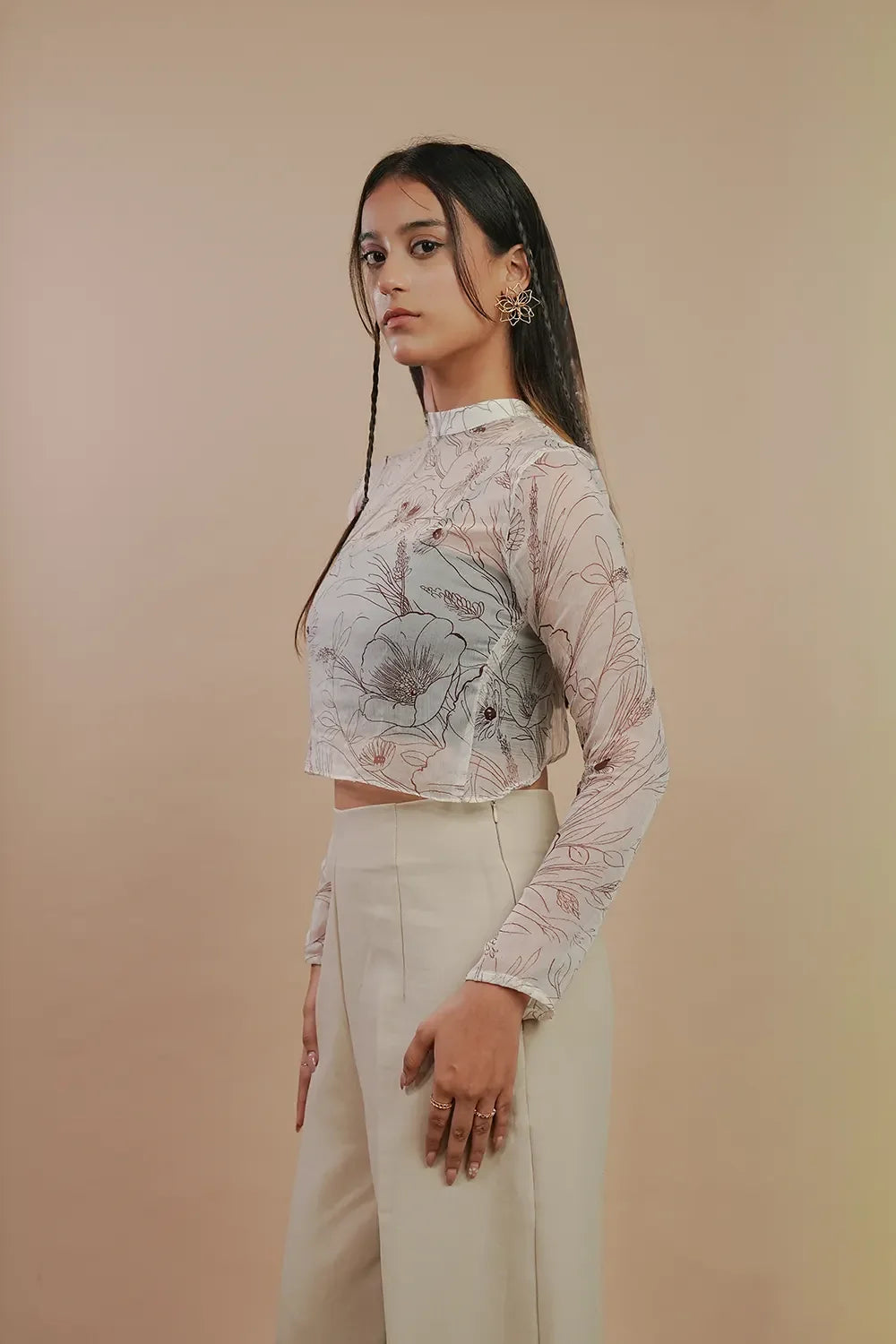 Woman in floral sheer long-sleeve crop top and beige pants, Streiq fashion style