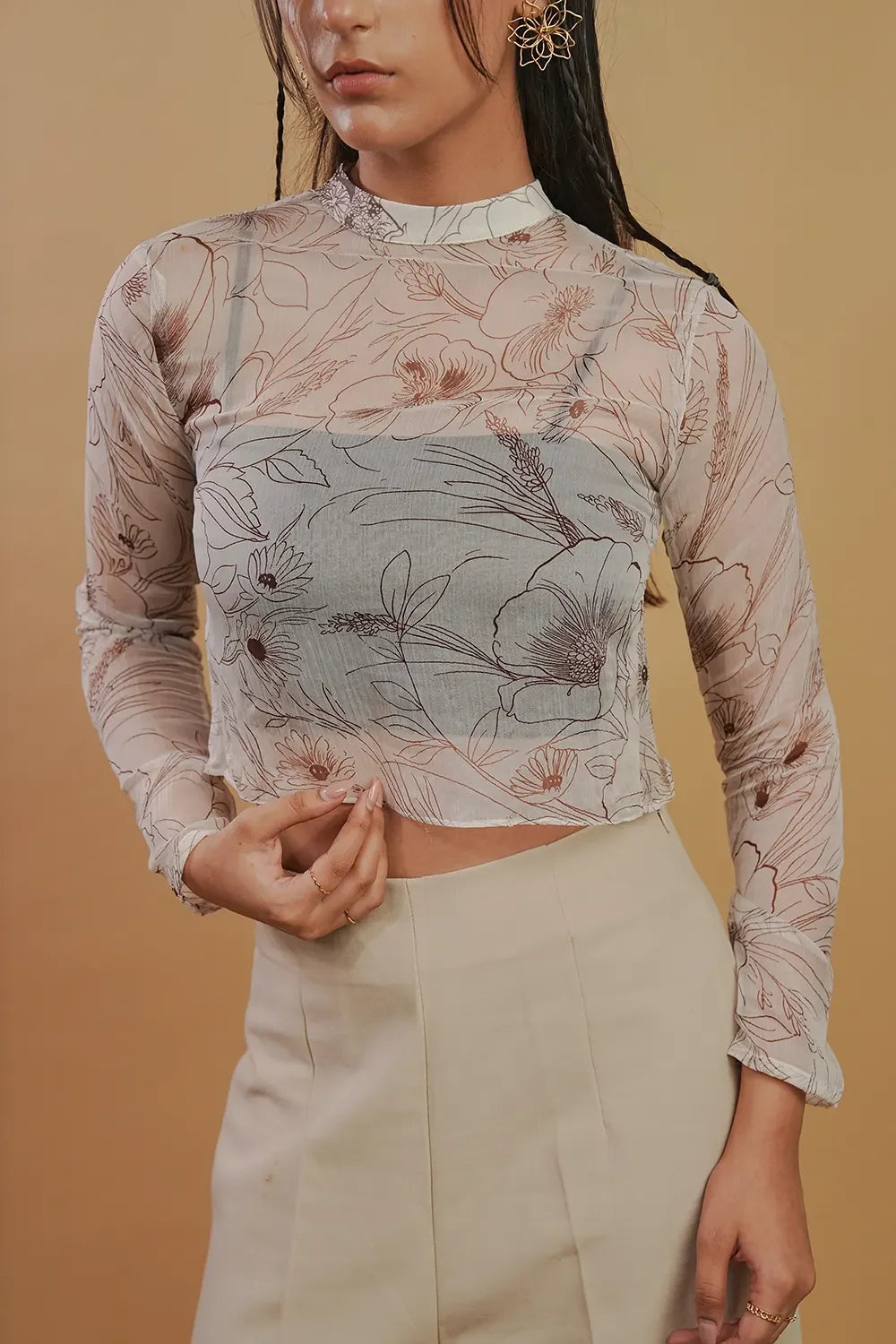 Woman modeling sheer floral long sleeve top and beige high-waist pants, Streiq fashion