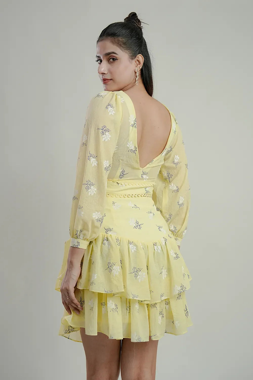 Woman wearing yellow floral ruffle dress with deep V-back, Streiq Uniquely You style