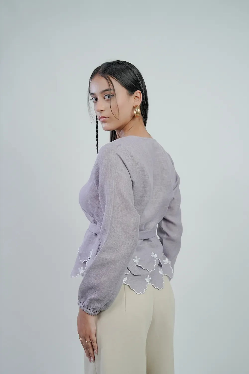Woman modeling lilac long-sleeve blouse with scalloped hem, Streiq fashion