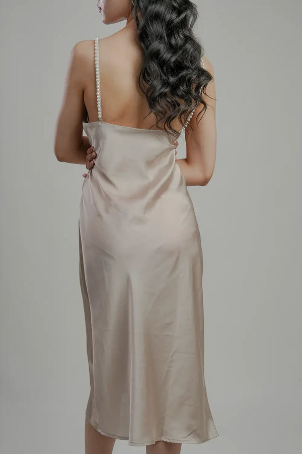 Back view of woman in pearl strap satin slip dress, Streiq fashion style